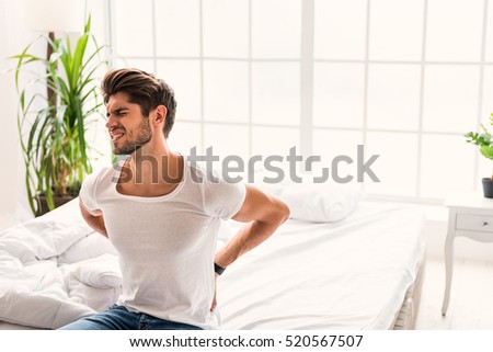 Frustrated guy feels pain in back