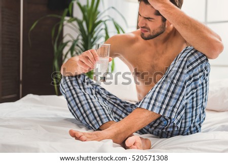 Sad guy suffering from hangover in morning