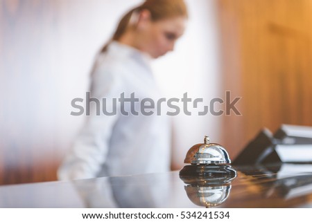 Woman working behind reception desk