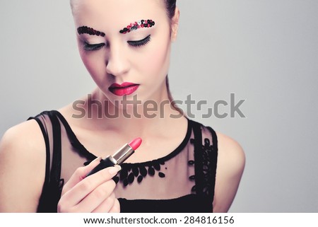Sexy Beauty Girl with Red Lips and Nails. Provocative Make up. Fashion Brunette Portrait isolated on a white background. Gorgeous Woman Face.