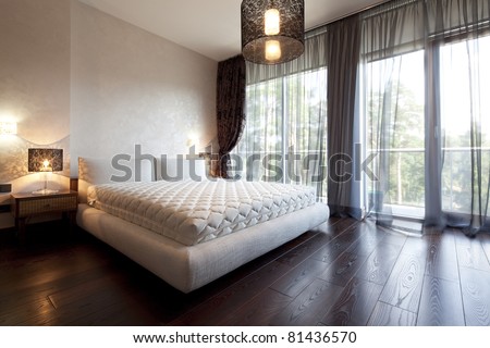 Interior of designer bedroom with beautiful view from window Interior of designer bedroom with beautiful view from window