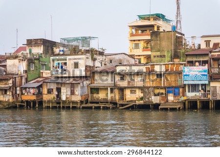 Houses and river/TienGiang, Vietnam â?? February 14th 2015: At afternoon, this view has many houses behind the river, in TienGiang, Vietnam