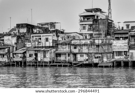 Houses and river. B&W/TienGiang, Vietnam â?? February 14th 2015: At afternoon, this view has many houses behind the river, in TienGiang, Vietnam