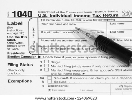 Federal Income Tax Document 1040, with a pen resting on top of the form.