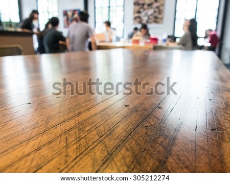 Group talking business in coffee shop selective focusing at wooden table