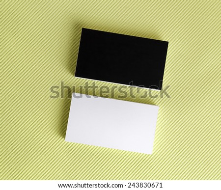 Blank black and white business cards on a green background. Template for ID. Top view.
