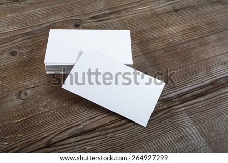 Photo of blank business cards on a wooden background. Template for ID. Top view.