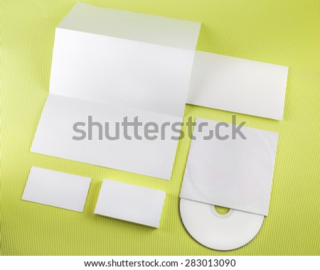 Photo of blank corporate identity set on green background.. Template for branding identity. Top view.