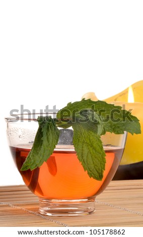 Mint and tea in a glass/Tea and Mint/Glass cup with tea and fresh mint leaf
