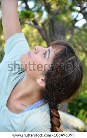 Woman outside doing yoga/Yoga in Nature/Young attractive woman doing yoga poses