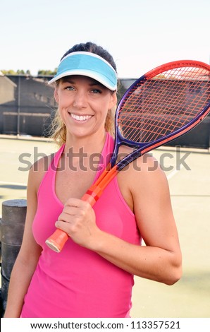 Woman tennis player with racquet/Woman Tennis Player/Physically fit young female tennis player