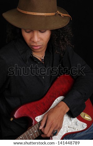 Young Afro American Guitar Player/Serious Guitar Player/Young man demonstrates his guitar skills as a musician.