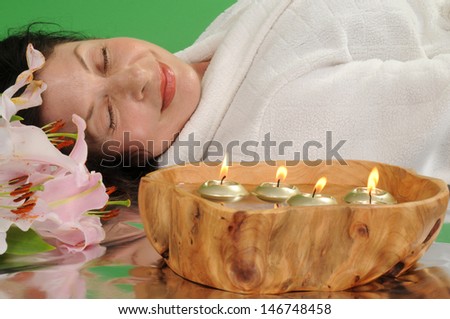 Woman relaxing in spa setting/Tranquil Woman/Woman in bathrobe enjoying a tranquil moment in a spa setting