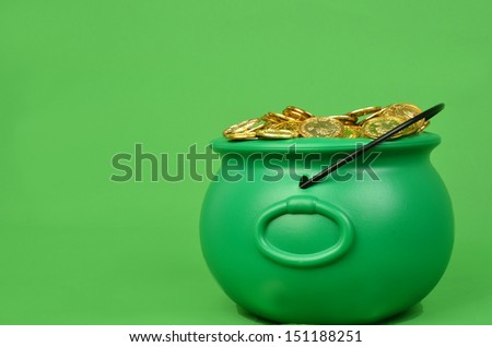 Green pot filled with gold coins/Pot of Gold/Pile of gold coins in a green caldron
