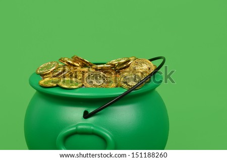 Green pot filled with gold coins/Pot of Gold/Pile of gold coins in a green pot