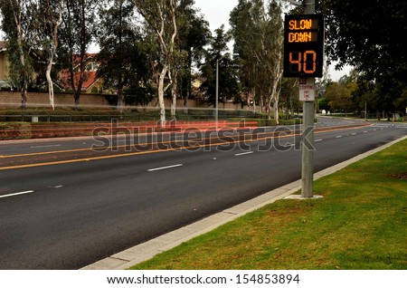 Speeding cars and traffic warning sign/Traffic Speed Zone.Illuminated traffic speed warning sign with speeding cars