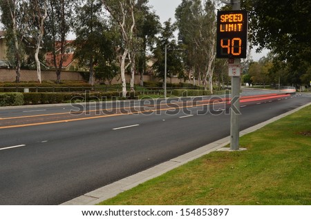 Speeding cars and traffic warning sign/Traffic Speed Zone.Illuminated traffic speed warning sign with speeding cars