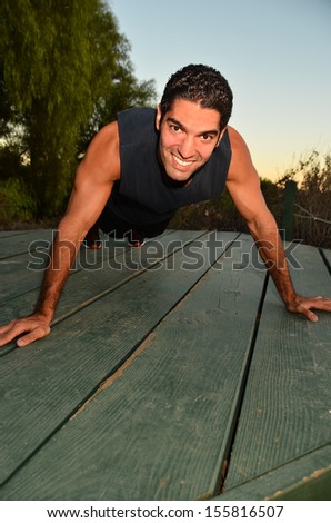 Young man exercising in outdoor environment.Physically Fir Man/Young man doing his exercises in an outdoor environment
