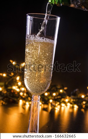 Sparkling Wine and Lights/Evening Celebration/ Glass filled with sparkling wine and lights