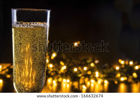 Sparkling Wine and Lights/Evening Celebration/ Glass filled with sparkling wine and lights