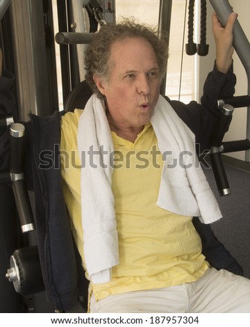 Senior man at his gym/Senior Exercising/Nab in gym clothes on fitness equipment