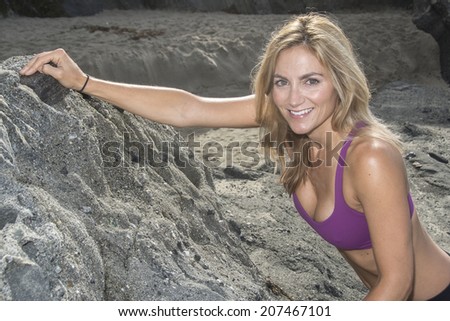 Woman getting ready for rock climbing/Woman Rock Climber/Woman in climbing attire ready to do rock climbing