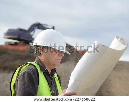 Senior construction man on a job site/Serious Construction Worker/Senior man with hard hat