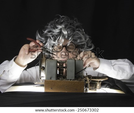 Older man with radio set/Radio Technician/Mature man working on a vintage radio