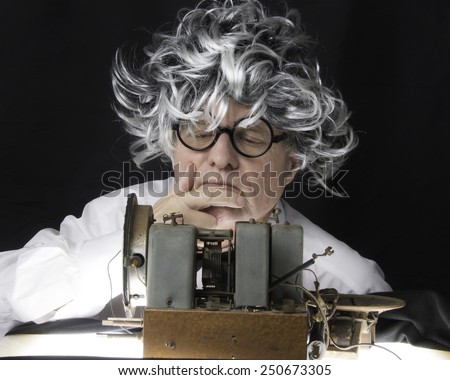 Older man with radio set/Radio Technician/Mature man working on a vintage radio