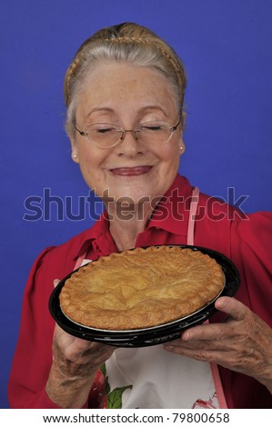 Grandmother with pie/Grandmother and Love/Senior woman or grandmother offering a pie