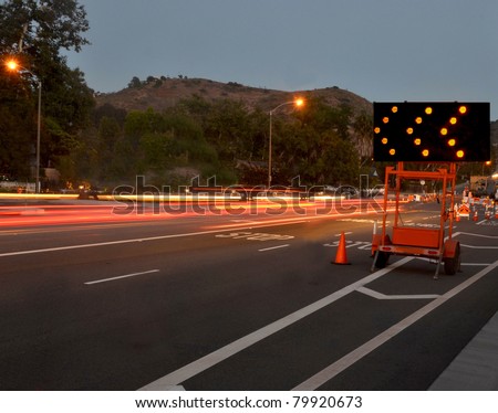 traffic passing by construction/Night Traffic Warning/Night traffic passing by a warning sign