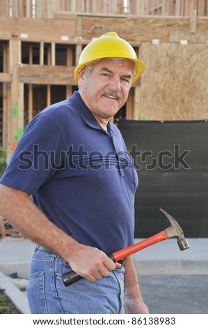 Man at a construction site/Mature construction worker/Man with hard hat working at a construction site