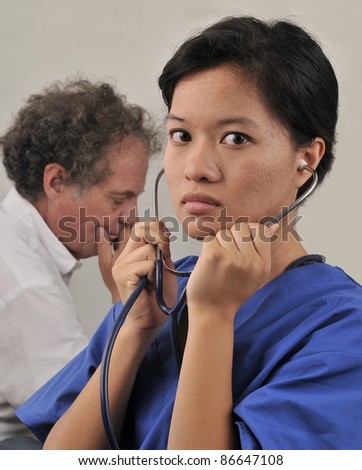 Doctor consulting patient/Asian female Doctor and Patient.Patient receiving news from doctor
