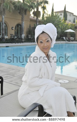 Asian Woman in white robe/Spa Day/Asian Woman relaxing in a spa setting