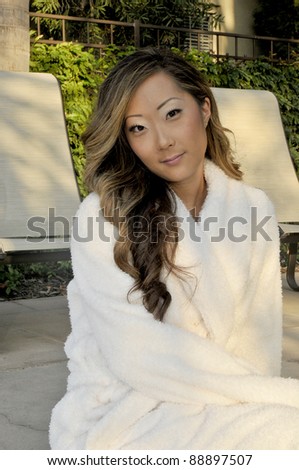 Asian Woman in white robe/Spa Day/Asian Woman relaxing in a spa setting