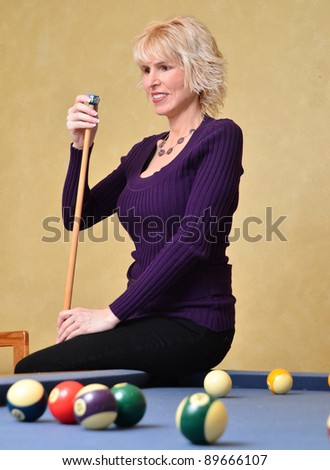 Woman at pool table/Woman at Pool Table/Woman playing a game of pool