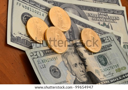 Gold coins on currency/Gold Coin and Currency/4 gold coins on paper currency
