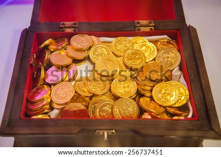 gold coin design chocolate display in the open wood box