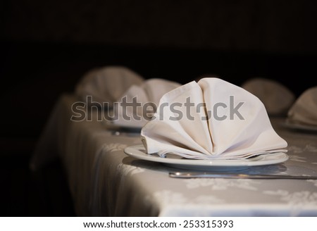Served table with napkins in dark restoran