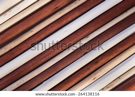 Wooden background from painted white, ivory and brown twigs