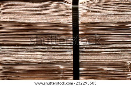 Closeup  shot of  daily newspapers stacked in a heap / Daily newspapers stacked in a heap/ Closeup  shot of  daily newspapers stacked in a heap (background,  closeup, newspapers)