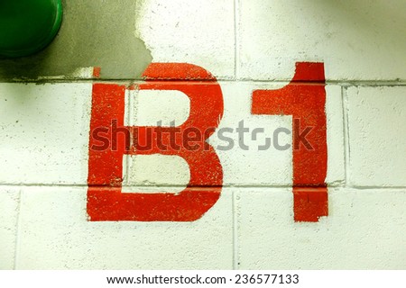 Red painted number B1 on a white brick wall and green pipe/ Red painted number B1 / Red painted number B1 on a white brick wall (number, red, brick)