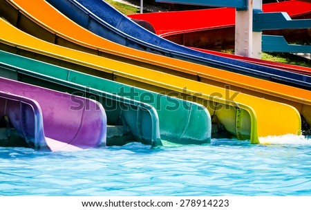 colorful plastic water-slide in swimming pool/ water slide in the aqua park / water slide in the aqua park . close up (water slide, water poor, swimming)