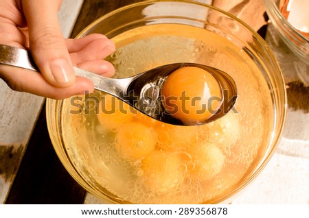 Egg yolk in vegetable oil. Selecting ingredients for cake/ Egg yolk in vegetable oil / Egg Yolk in vegetable oil Close Up Background (egg, yolk, ingredients )