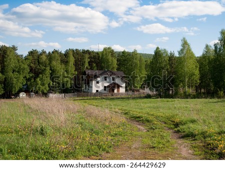 White house in the forest. Summer. Road . Russia Siberia Krasnoyarsk