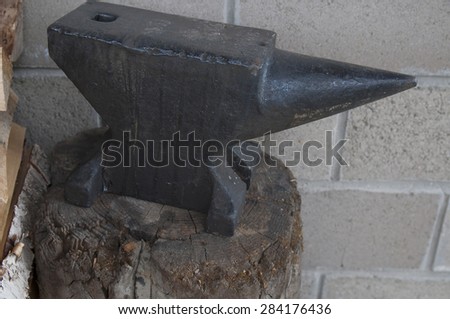anvil on the old wooden chock
