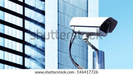 Two Security Cameras in a Modern Building Facade