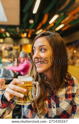 Young Woman Having a Beer in a Traditional Market