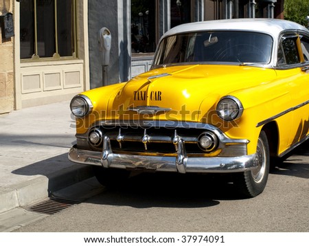 stock photo Typical yellow cab of the 50s 60s in a old american town