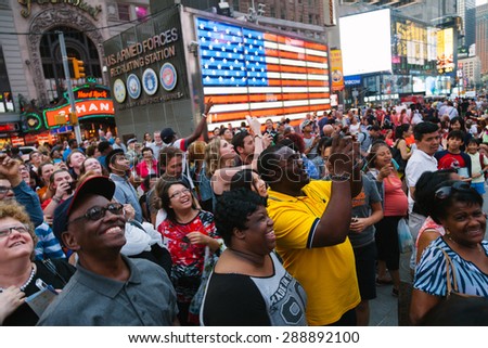 NEW YORK CITY - JUNE 11: People having fun with the Screen Shows in Times Square, one of the most visited landmarks of the world on June 11, 2015 in Manhattan, New York City